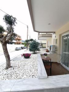 a house with a gravel yard with a tree in it at Sfendamos Residence Kavala in Kavála