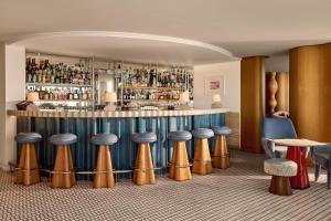 a bar with a bunch of stools in a room at The Maybourne Riviera, Maybourne in Roquebrune-Cap-Martin +53 photos