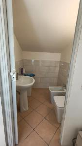 a bathroom with a sink and a toilet at Casa Vacanze Sofì in Ascea