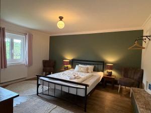 a bedroom with a bed and a green wall at Kirchstett in Sankt Wolfgang