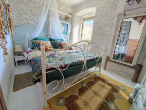 a small bedroom with a bed with a canopy at Villa Lido 145 m2 with pool in Krnica +41 photos