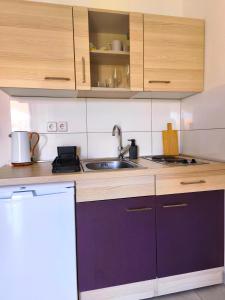 a kitchen with a sink and a counter top at Studio Stela 3 in Povljana