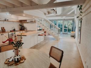 a kitchen and dining room with a table and chairs at Slow Haus Tanunda in Tanunda