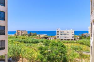 a view of the ocean from a building at Mauve et Miel 2-BR Apartment In Batroun in Batroûn