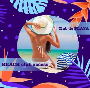 a woman in a hat sitting on a surfboard at the beach at TROPICAL RETREAT SUITES at PLAYA LOS CORALES in Punta Cana