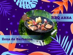 a person is cooking food on a grill at TROPICAL RETREAT SUITES at PLAYA LOS CORALES in Punta Cana
