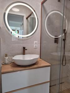 a bathroom with a white sink and a mirror at Start na Szlak - dom Rytro in Rytro