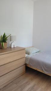 a bedroom with a bed and a wooden dresser at Start na Szlak - dom Rytro in Rytro +9 photos