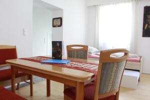 a dining room with a table and two chairs at Stay-In Vienna 23 in Vienna