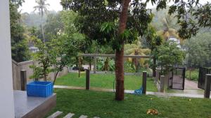 a park with a tree and a playground at Monara Blue Beach in Dickwella