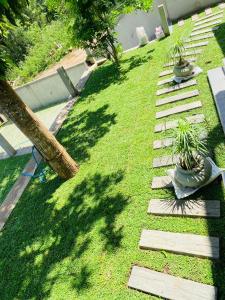 a garden with two potted plants on the grass at Monara Blue Beach in Dickwella