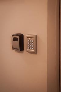 a lock on a door with a toaster on it at Apparts' Rennes BnB Solferino in Rennes +24 photos