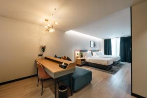 a hotel room with a bed and a desk at Orchid Parc Bengaluru - Manyata Business Park in Bangalore +128 photos