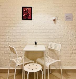 a table and two chairs and a table and a table at Electrifying Pearl in Bangalore +2 photos