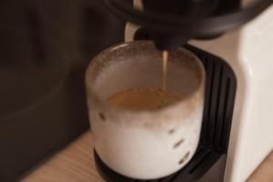 a person is making a drink in a blender at Apparts' Rennes BnB Solferino in Rennes