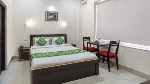 a bedroom with a bed and a table and chairs at Zouk Homes in Rishīkesh