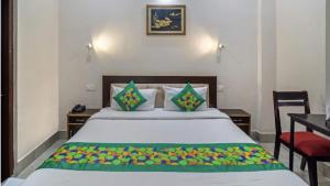 a bedroom with a bed with a table and a desk at Zouk Homes in Rishīkesh
