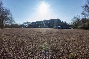 a building with a car parked in a parking lot at La MASSERIA in Thuin +1 photo