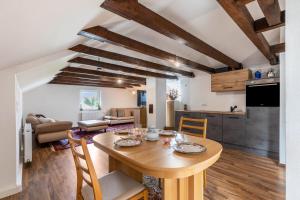 a kitchen and living room with a wooden table and chairs at Loft in Augsburg