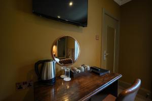 a dressing table with a mirror on a wall at The Whisky Vaults in Oban