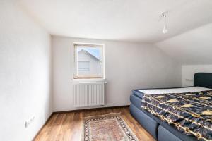 a bedroom with a bed and a window at Loft in Augsburg