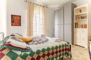 a bedroom with a bed and a book shelf at Casa della Nonna - Art & Vintage Rooms in Noicattaro