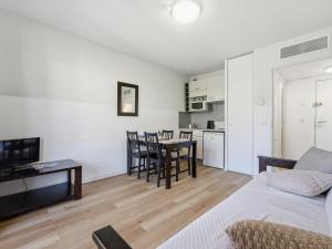 a living room with a table and a kitchen at Virginia N214 2P4 in Grasse