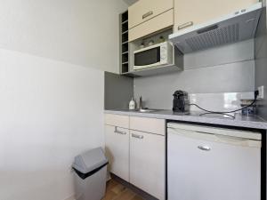 a small kitchen with a sink and a microwave at Virginia N214 2P4 in Grasse