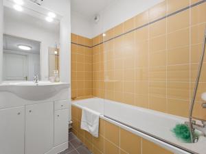a bathroom with a sink and a tub and a mirror at Virginia N214 2P4 in Grasse