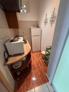 a small kitchen with a sink and a refrigerator at Blu in Glida +161 photos