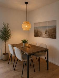 a dining room with a wooden table and chairs at Apartment Illerblick in Dettingen an der Iller