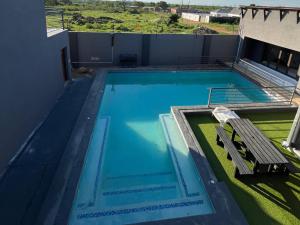 a swimming pool on the roof of a house at Giyani Shamba Lodge in Giyani