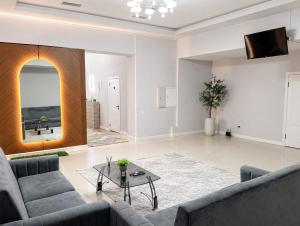 a living room with a couch and a table at Grand Sky Hotel in Almaty