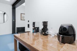 a wooden counter top with a coffee maker on it at Modern Zurich Apt with Balcony View & Workspace in Zurich