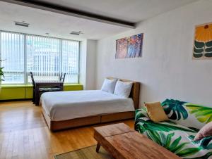 a hotel room with a bed and a couch at Cozy - Bright Studio in Incheon