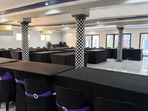 a large room with tables and chairs in it at Giyani Shamba Lodge in Giyani