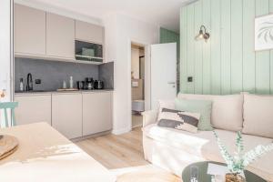 a living room with a couch and a kitchen at Green Village Igelnest in Benz +34 photos