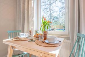 a dining room table with a candle and a table with chairs at Green Village Igelnest in Benz