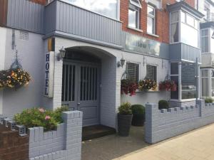 a building with a door and flowers on it at Mallowview guest house in Cleethorpes