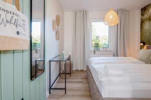 a bedroom with a bed and a glass table at Green Village Igelnest in Benz