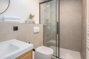 a bathroom with a shower and a toilet and a sink at Green Village Igelnest in Benz