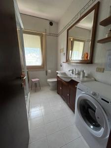 a bathroom with a washing machine and a sink at Casa Vacanze Revè in Possagno +12 photos