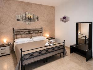 a bedroom with a bed and a mirror and a sink at Agriturismo Caranna in Torre Lapillo +24 photos