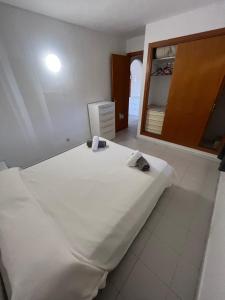 a bedroom with a large white bed and a mirror at Portobello Verena in Port de Pollensa +21 photos