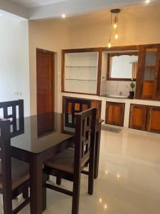 a dining room table and chairs in a kitchen at Zenways in Varkala