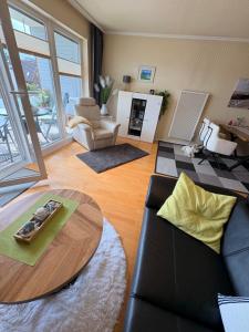 a living room with a couch and a table at Ostseeliebe in Grömitz