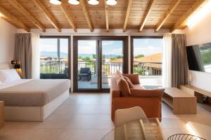 a hotel room with a bed and a balcony at Kallisti Luxury Rooms in Ierissos