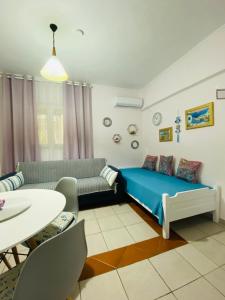 a bedroom with a bed and a couch and a table at FERRUM house in Hanioti