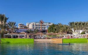 a person swimming in the water near a beach at Elysees Dream Beach Hotel-By AMARINA Hotels & Resorts in Hurghada