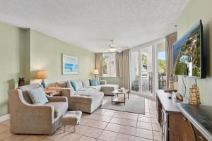 a living room with two couches and a tv at North Breakers - Unit 202, Wood Ave in East End